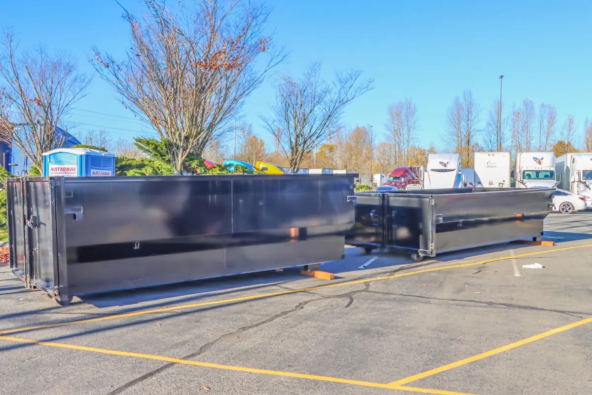 Professional dumpster rental service with roll-off container on residential driveway in Upper Pottsgrove